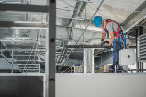 male commercial hvac technician assembling hvac unit in warehouse