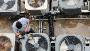 HVAC technician performing AC unit tune up